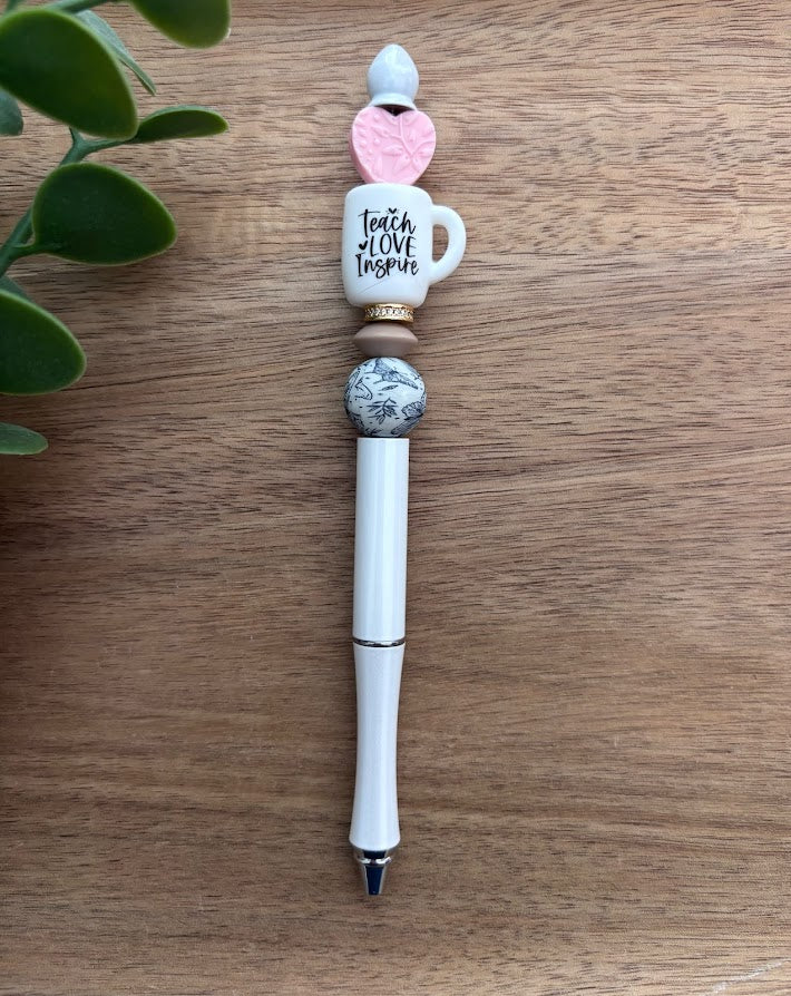 Decorative pen with ceramic beads on a wooden surface