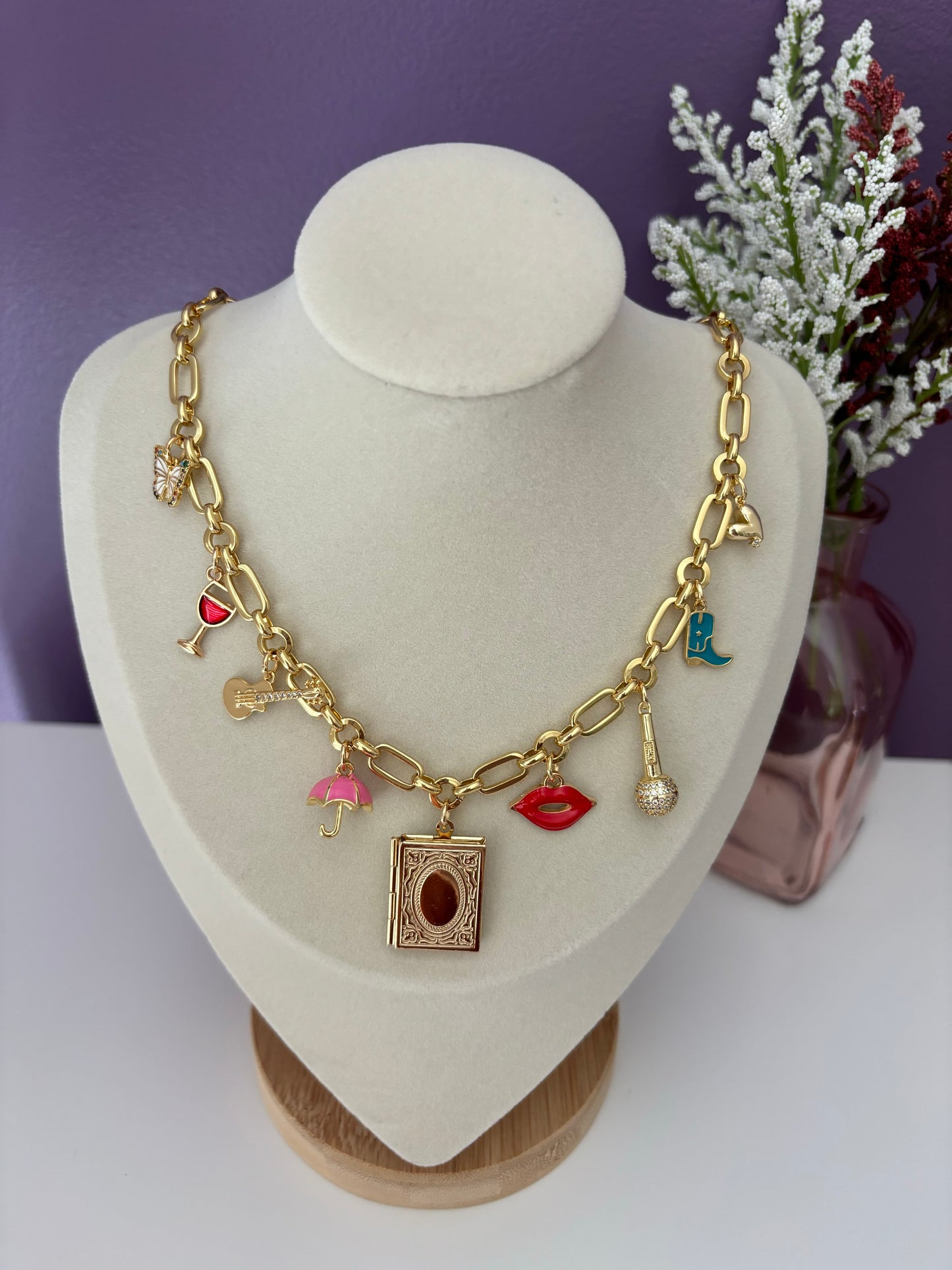 Taylor swift eras inspired charm necklace with butterfly, wine, guitar, umbrella, book, lips, microphone, cowgirl boot, and heart