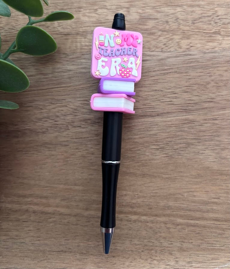 Pen with a decorative top on a wooden surface