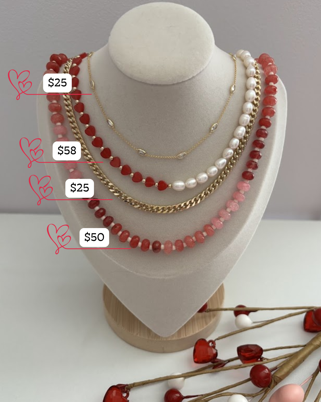 Necklaces on a mannequin bust with price tags, surrounded by decorative elements.